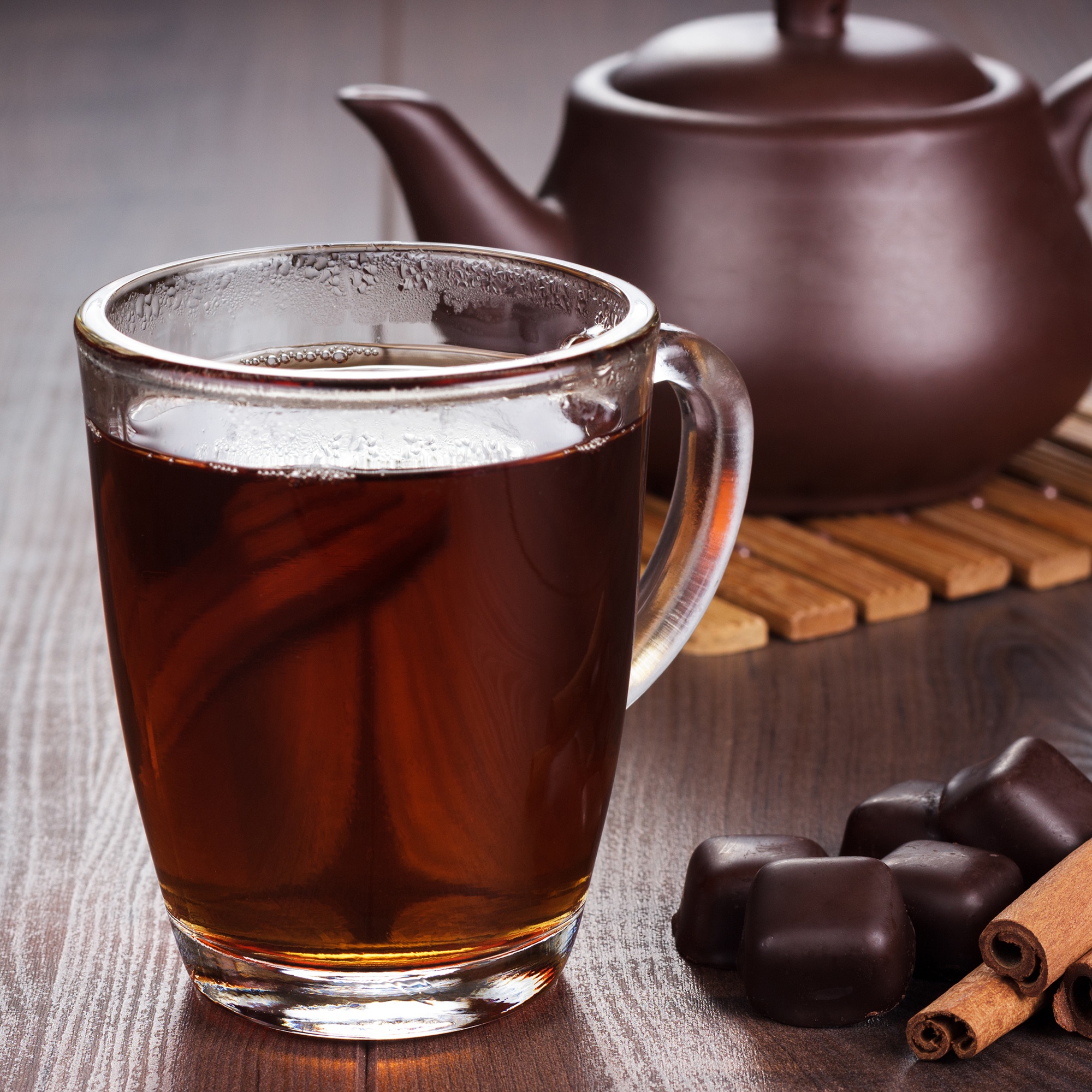 Cup Of Tea With Cinnamon Sticks And Teapot